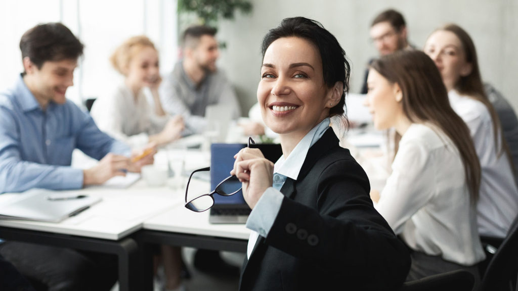 A CEO chairing a meeting of the management in her organisation